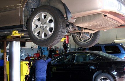 Vehicle on a repair rack at a dealership service center — NC lemon law repair attempt documentation