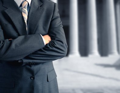 NC lemon law attorney standing confidently outside courthouse — Norris Law Firm PLLC fights for North Carolina consumers